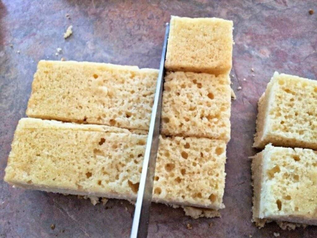 Image shows cake sliced into squares.