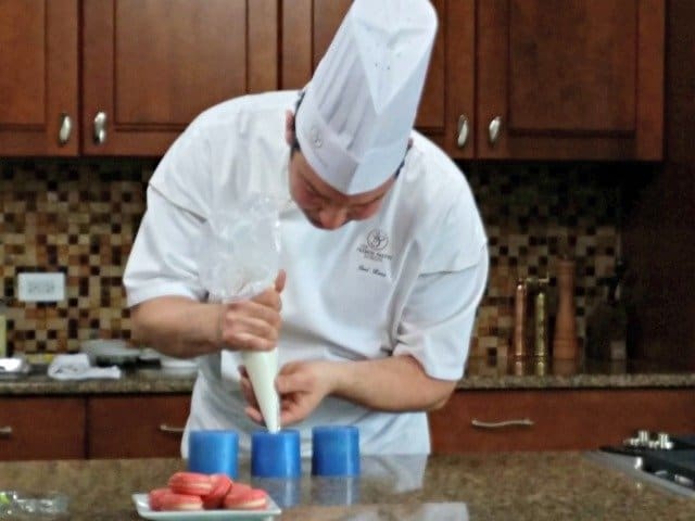 Piping yogurt mousse into molds for presentation