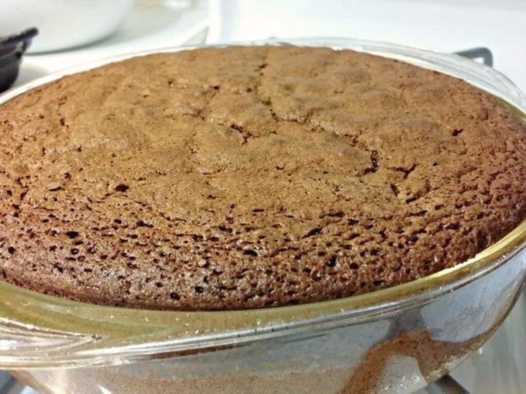 Image shows baked chocolate olive oil cake.