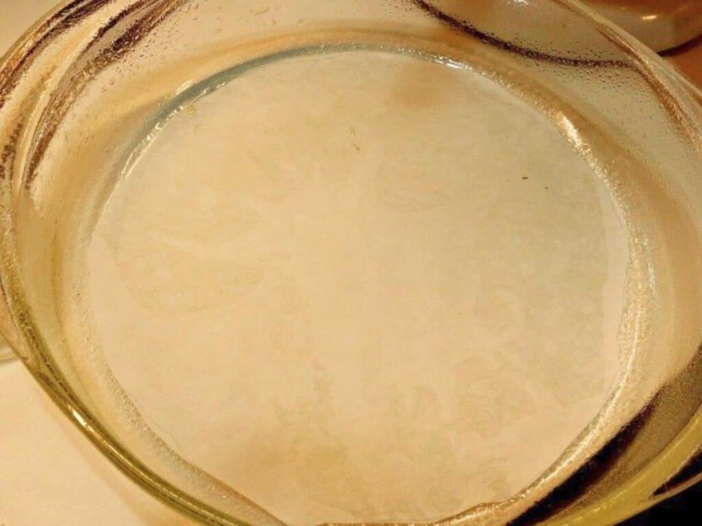 Image shows round cake pan upside down.