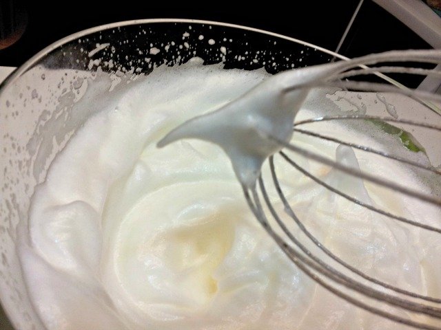 Beating eggs to a stiff peak should have the peak remain without falling over when you pull the spatula from the eggs