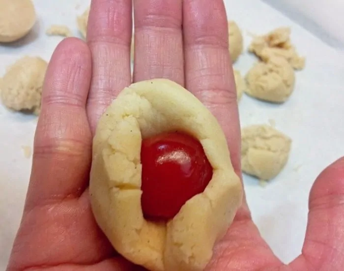 fold cherry inside the cookie dough