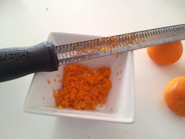 Zest oranges for caramel sauce before juicing them