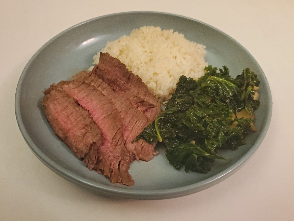 Asian marinated steak on a plate with sides.