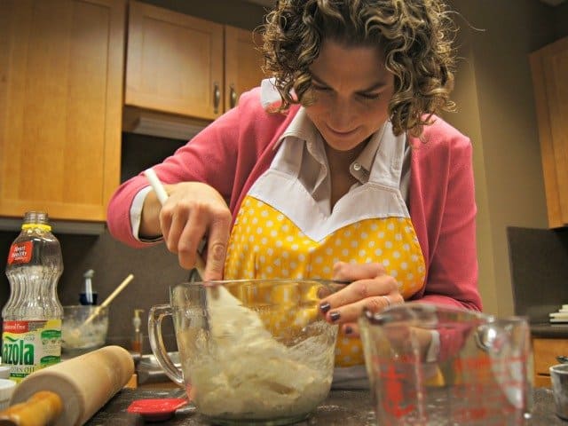 Mixing pizza dough with a spoon before kneading