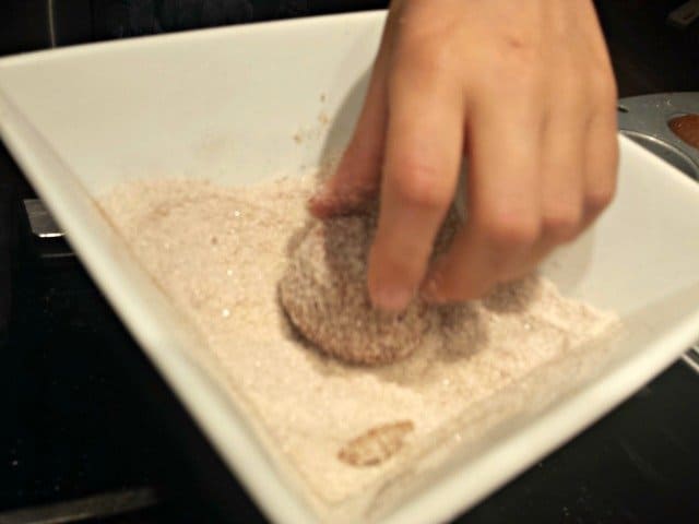 Roll donuts in cinnamon sugar