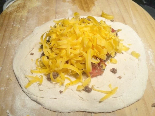 Top your taco pocket filling with plenty of shredded cheddar cheese