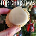Cookie held in front of a Christmas tree with text lemon cookies for Christmas.