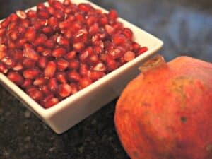 Pomegranate and seeds in a bowl