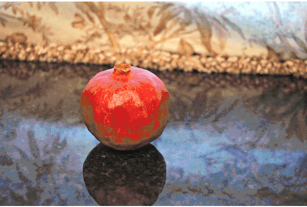 GIF showing how to cut a pomegranate