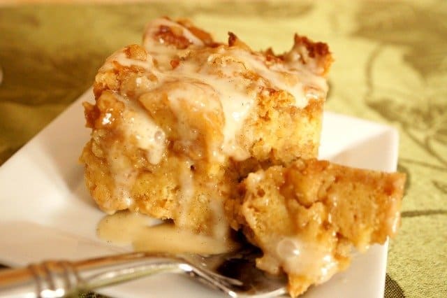 Image shows a bit of Cinnamon roll bread pudding on a fork.