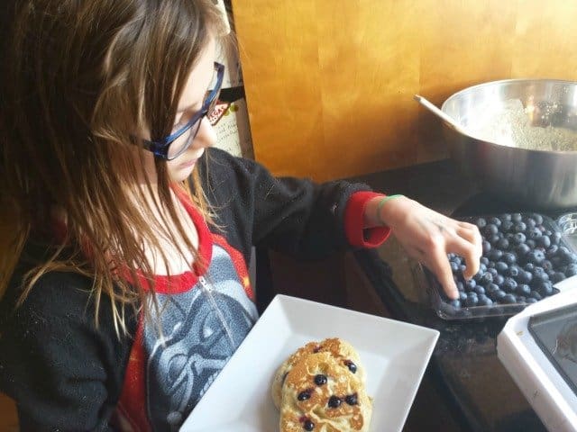 Eating blueberry pancakes