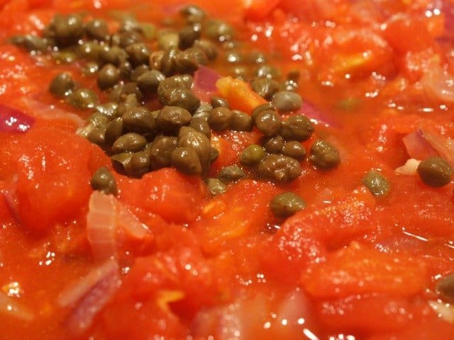Add capers and tomatoes