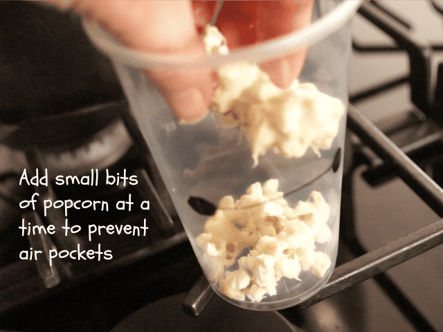 Adding marshmallow popcorn to Baymax cups