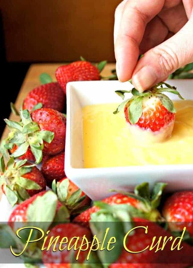 Dipping a strawberry in homemade pineapple curd
