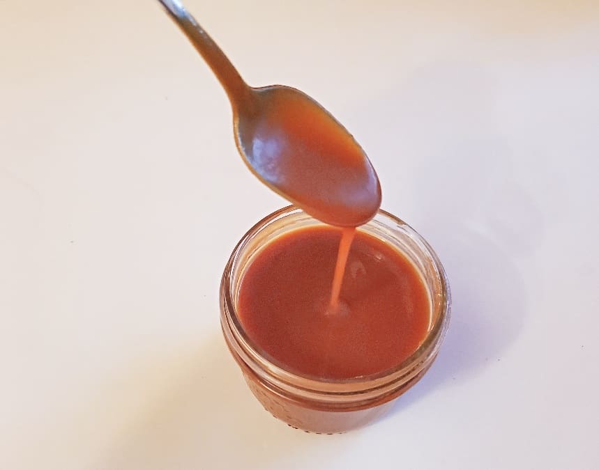 Spoon dripping caramel sauce