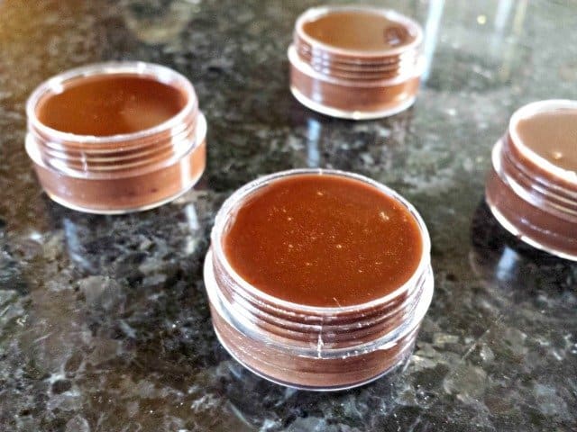 Homemade chocolate lip balm in containers