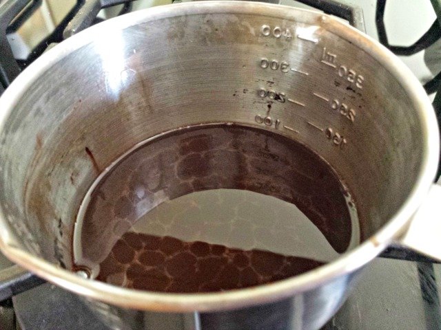 Cocoa powder is mixed into homemade lip balm liquid