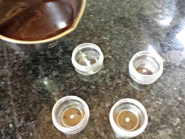 Pour homemade chocolate lip balm into bead storage containers