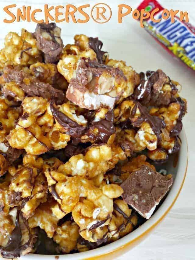 This Snickers popcorn recipe is a perfect sweet treat. Homemade caramel corn drizzled with chocolate and soft Snickers pieces inside combine for a delicious unique popcorn recipe. #popcorn #snickers #caramelcorn #homemade