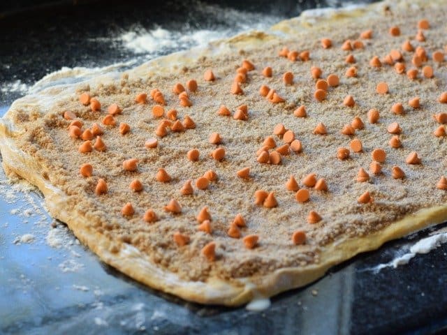 Brush with melted butter and streusel mixture then top with morsels