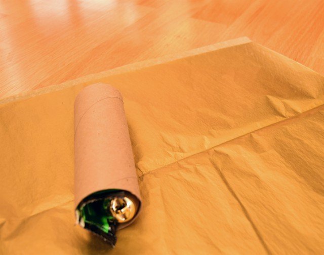 Fill cardboard rolls with gifts and place on tissue paper
