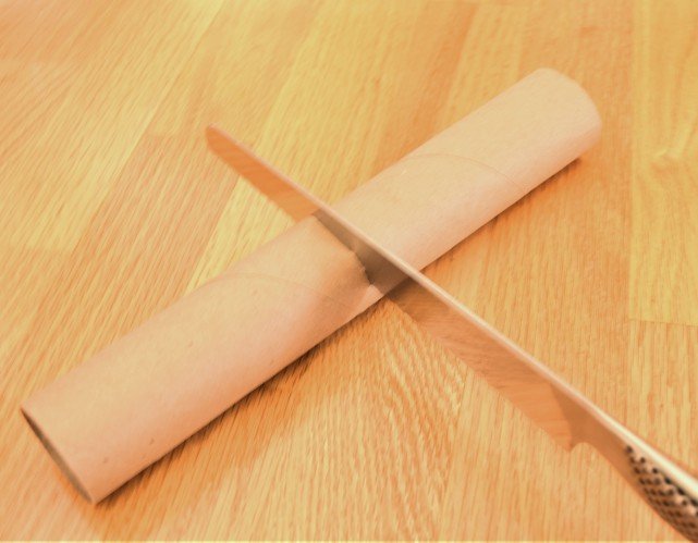 Slice paper towel rolls in half with a serrated knife