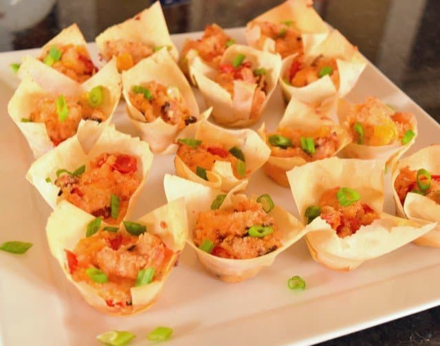 Tomato bacon cups ready to serve with green onion garnish