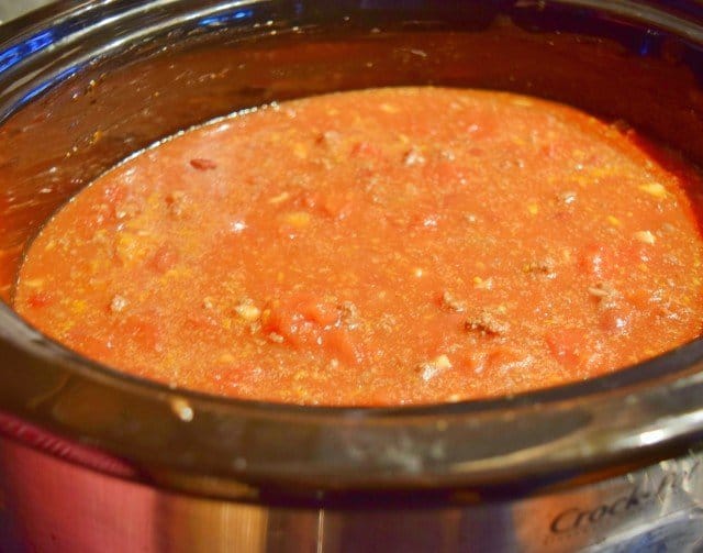 Add tomatoes and beans to meat and onion