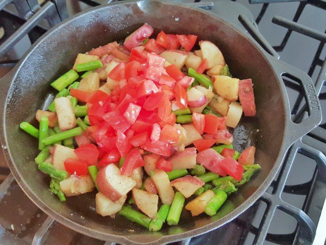 Add tomatoes to asparagus and potatoes