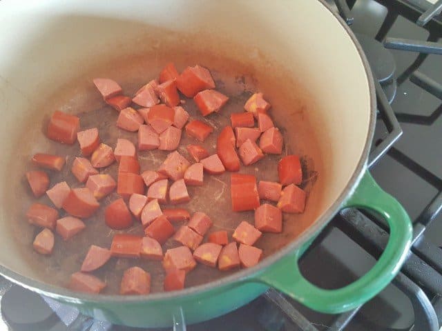 Brown sausage in soup pan
