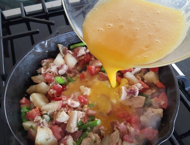 Pour beaten egg over nicoise dinner omelet mixture