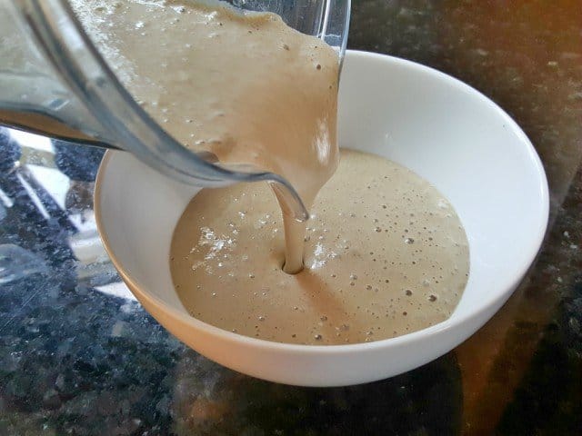 Pour strawberry banana smoothie into bowl