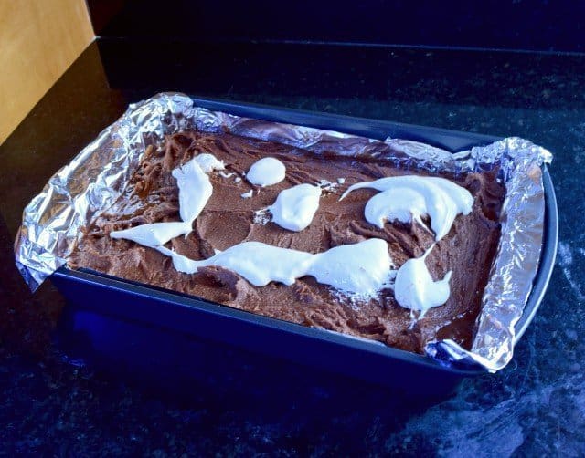 Add marshmallow fluff atop brownie batter
