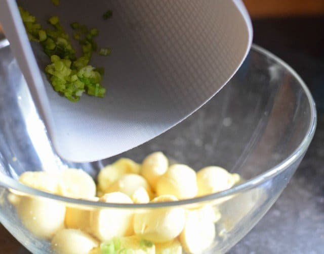 Add chopped green onion to egg yolks for bacon deviled eggs
