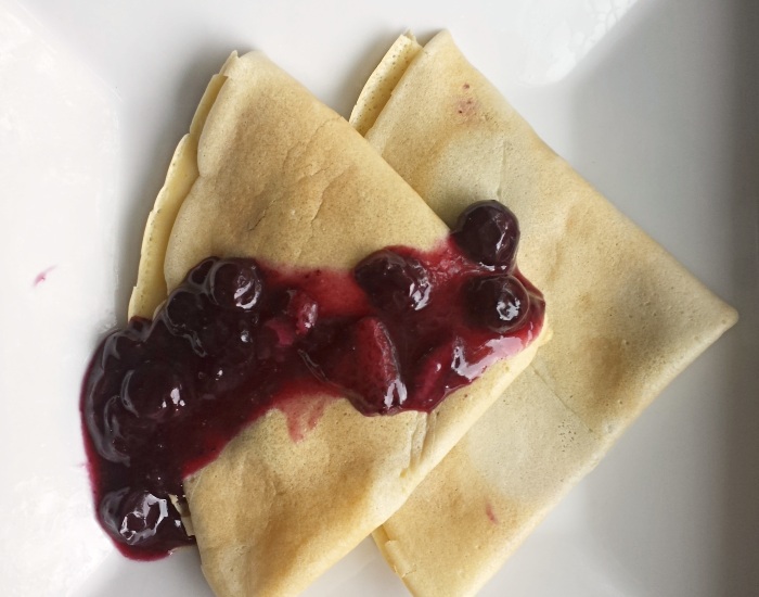Blueberry syrup on crepes