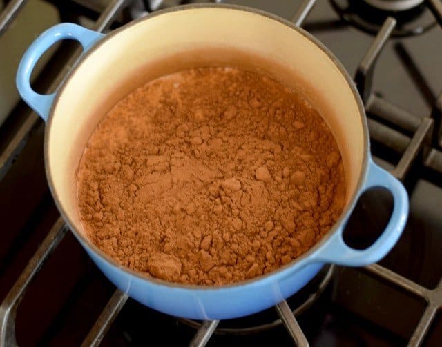 Add ingredients to the pot for espresso hot fudge sauce and boil