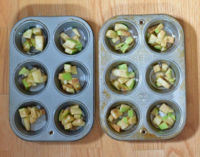 Add chopped apples to muffin tins