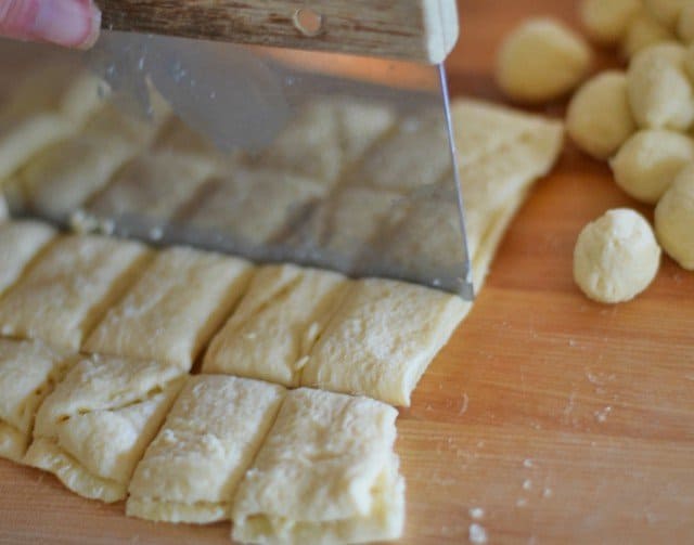 Use a bench scraper to cut the crescent roll dough