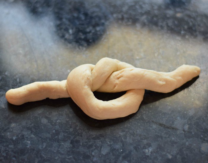 Tie snake into loose knot