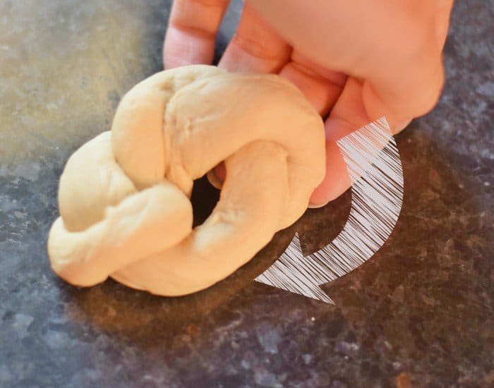 Tuck remaining end underneath knot