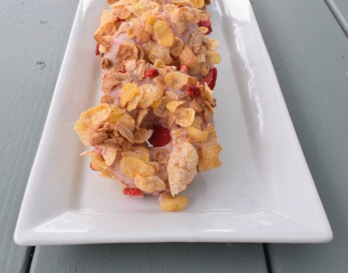 Plate of strawberry cereal topped donuts