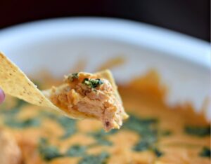 Bite of delicios smoky cheesy chicken enchilada dip