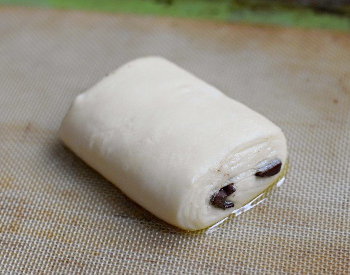 Fully proofed chocolate croissant ready to bake