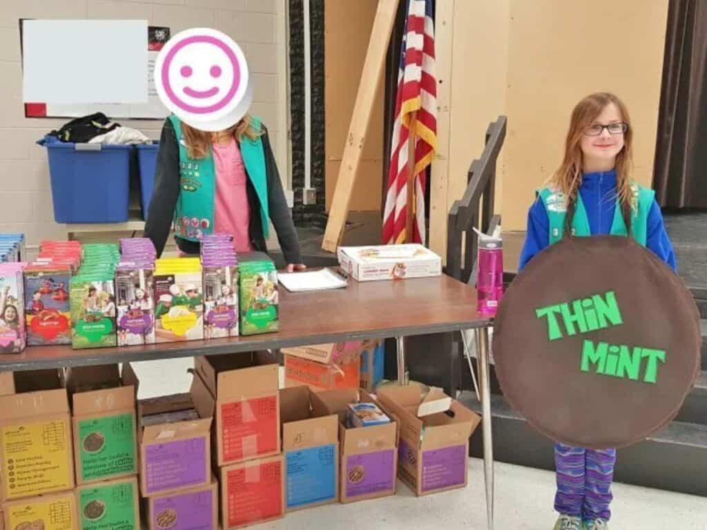 Image shows girl wearing a costume for the Girl Scout cookies booth.