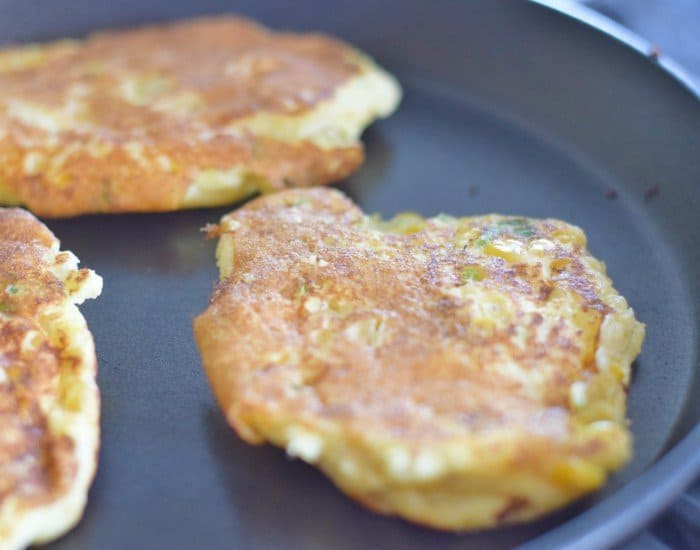 Flip corn fritters after two minutes then cook the other side