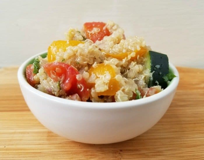 Image shows shows a closeup of Tomato Quinoa Salad in a small white bowl.
