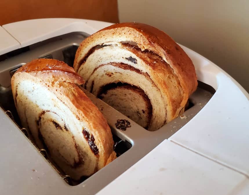 Slices of cinnamon raisin bread in a toaster