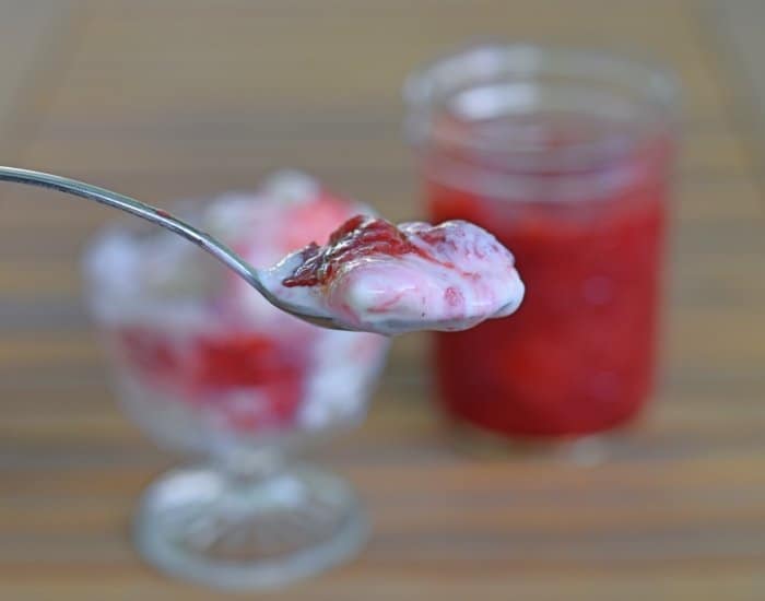 Scoop of ice cream with strawberry syrup