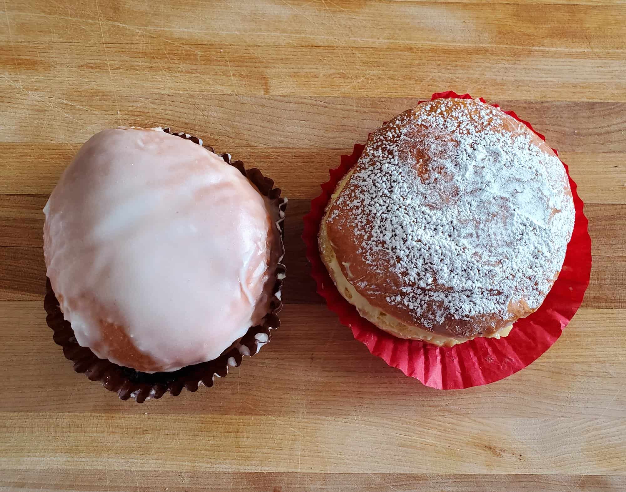 Aracelys Bakery paczki shot from overhead on a wooden cutting board.